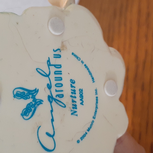 Pretty Angel holding a baby - Picture 4 of 4